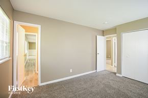 Indianapolis house for rent - a bedroom with a carpeted floor and a door to a hallway