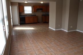 Indianapolis house for rent - an empty kitchen and living room with tile flooring