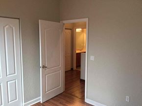 Homestead house for rent - a bedroom with a door open to a hallway and a bathroom