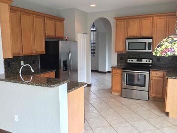 Homestead house for rent - a kitchen with granite counter tops and stainless steel appliances