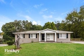 Marietta house for rent - a small brick house with a yard and a tree