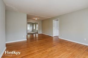 Marietta house for rent - the living room and dining room of an empty house with wood floors