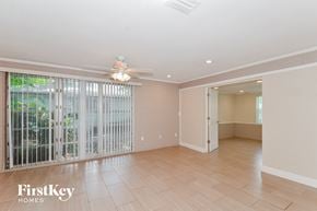 Bradenton house for rent - A spacious room with a sliding glass door leading to a balcony.