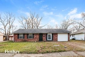 Indianapolis house for rent - the front of a brick house with a grassy yard