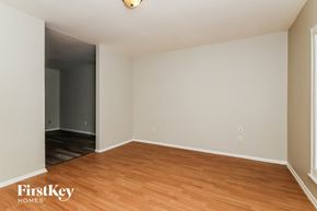 Indianapolis house for rent - an empty living room with wood flooring and white walls