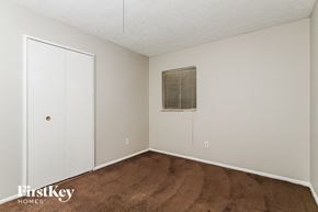 Indianapolis house for rent - a bedroom with a carpet and a door to a closet