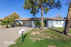 Phoenix house for rent - a white house with a mailbox on the side of the road