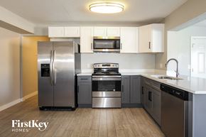 Phoenix house for rent - a kitchen with stainless steel appliances and white cabinets