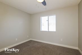 Phoenix house for rent - a bedroom with white walls and carpet and a window