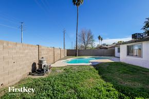 Phoenix house for rent - a backyard with a pool and a house