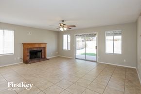 Glendale house for rent - A spacious room with a fireplace and sliding glass doors.