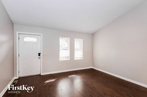 Gainesville house for rent - a bedroom with white walls and wood floors and a white door