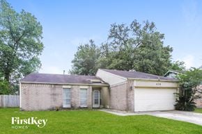 Spring house for rent - a small brick house with a yard and a garage