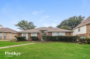 Garland house for rent - a brick house with a grass lawn and a sidewalk