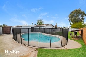 Phoenix house for rent - a large pool with a fence around it in a backyard