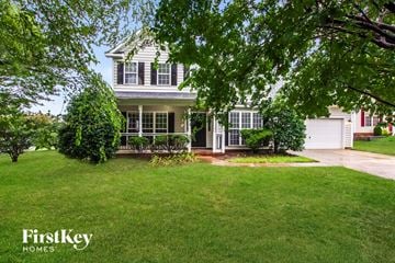Indian Trail house for rent - a house with a lawn and trees in front of it