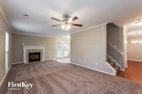 Indian Trail house for rent - an empty living room with a ceiling fan and a fireplace