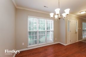 Indian Trail house for rent - an empty dining room with a large window and a chandelier