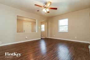 St. Petersburg house for rent - the living room of an empty house with wood floors and a ceiling fan