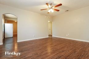 St. Petersburg house for rent - the living room and dining room with hardwood flooring and a ceiling fan