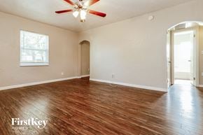 St. Petersburg house for rent - an empty living room with wood flooring and a ceiling fan