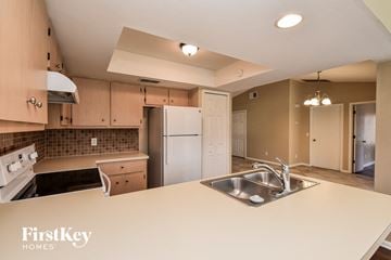 Cape Coral house for rent - a kitchen with a white counter top and a sink