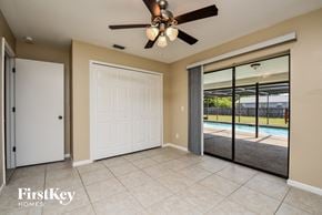 Cape Coral house for rent - a room with a ceiling fan and a door to a pool