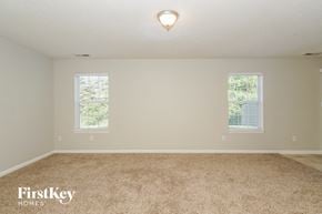 Indianapolis house for rent - A room with a carpeted floor and two windows.