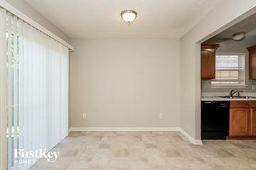 Indianapolis house for rent - A kitchen area with a black dishwasher and wooden cabinets.