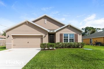 Port St. Lucie house for rent - a beige house with a lawn in front of it