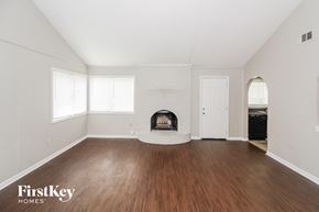 Memphis house for rent - a living room with a fireplace and wooden floors