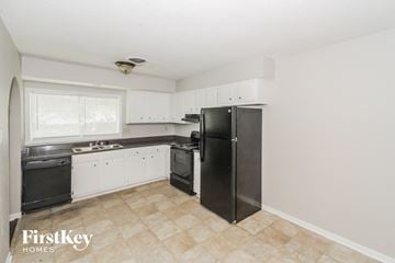 Memphis house for rent - a kitchen with black appliances and white cabinets