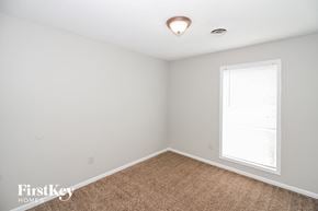 Memphis house for rent - a bedroom with white walls and carpet and a window
