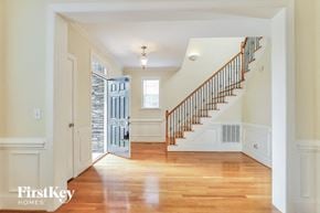 Greensboro house for rent - A spacious hallway with a staircase leading to the second floor.