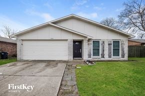 Fort Worth house for rent - A white house with a black door and windows is for sale.