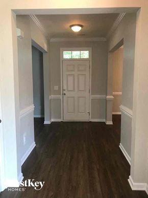 Winston-Salem house for rent - a view of a hallway with a white door and wood floors