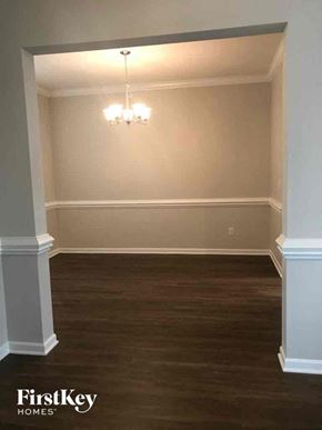 Winston-Salem house for rent - a empty dining room with wood flooring and a chandelier