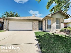 Fort Worth house for rent - A house with a garage door that says FirstKey Homes.