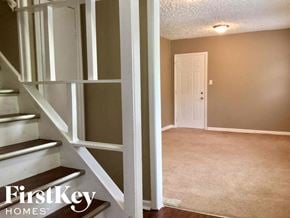 Indianapolis house for rent - a walk in closet with white shelves and a white door