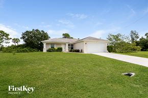 Lehigh Acres house for rent - A house with a lawn in front of it.