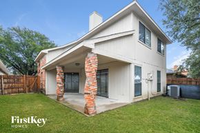 Mesquite house for rent - a white house with brick columns and a grass yard