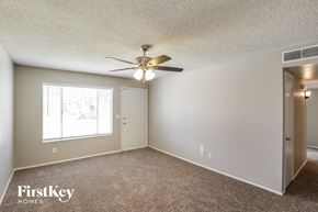 Phoenix house for rent - a bedroom with a ceiling fan and a window