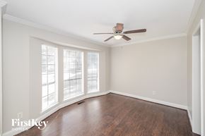 Helena house for rent - A room with a ceiling fan and sliding glass doors.