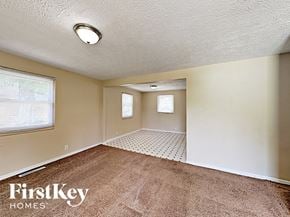 Indianapolis house for rent - A room with a carpeted floor and a window with blinds.