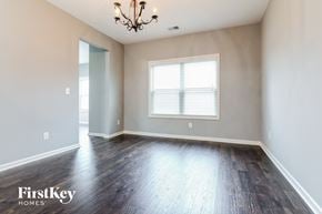 Gainesville house for rent - an empty living room with wood floors and a window