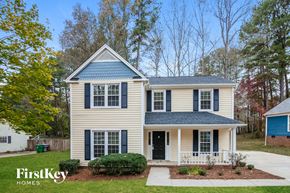 Charlotte house for rent - A two-story house with a blue roof and white walls.