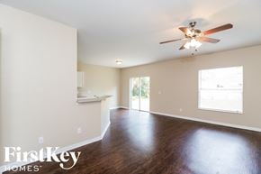 North Port house for rent - a living room with wood floors and a ceiling fan