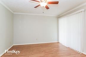 Katy house for rent - a living room with white walls and a ceiling fan