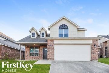Fort Worth house for rent - a house with a white garage door and a brick house