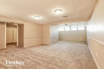 Florissant house for rent - a spacious living room with carpet and a closet
